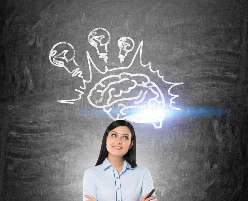 Girl black hair brain light bulbs close up smiling standing near blackboard three bulb sketches concept 79793907